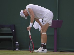 Canada's Denis Shapovalov pauses during the men's singles match against Russia's Roman Safiullin on day seven of the Wimbledon tennis championships in London, Sunday, July 9, 2023. Shapovalov is withdrawing from the National Bank Open in Toronto due to a knee injury, Tennis Canada announced Tuesday.