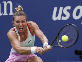 FILE - Simona Halep, of Romania, returns a shot to Daria Snigur, of Ukraine, during the first round of the U.S. Open tennis championships Aug. 29, 2022, in New York. Halep was dropped from the U.S. Open field on Monday, Aug. 21, 2023, because of a provisional doping suspension.