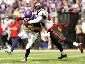 Kirk Cousins of the Minnesota Vikings is tackled by Devin White of the Tampa Bay Buccaneers.