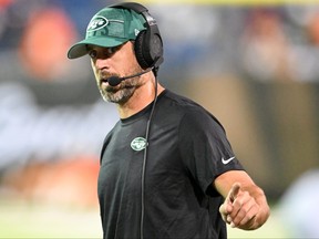 Aaron Rodgers #8 of the New York Jets looks on during a delay in the second half of the 2023 Pro Hall of Fame Game against the Cleveland Browns at Tom Benson Hall Of Fame Stadium on August 3, 2023 in Canton, Ohio.