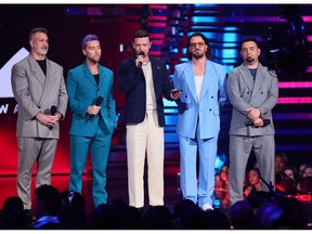 Joey Fatone, Lance Bass, Justin Timberlake, JC Chasez, and Chris Kirkpatrick of *NSYNC speak onstage the 2023 MTV Video Music Awards at Prudential Center on September 12, 2023 in Newark, New Jersey.