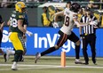 The Edmonton Elks' Adam Konar (38) looks on as the B.C. Lions' Justin McInnis (18) scores a touchdown during first half CFL action at Commonwealth Stadium, in Edmonton Friday Sept. 22, 2023.