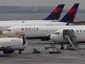 Delta Airlines passenger aircrafts are seen on the tarmac of John F. Kennedy International Airport in New York, Dec. 24, 2021.
