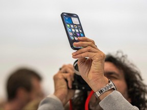 A person photographs the Apple iPhone 15 Pro during a launch event at Apple Park in Cupertino, Calif., on Tuesday, Sept. 12, 2023.