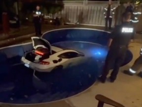 A white car ends up in a Brampton backyard swimming pool on the evening on Thursday September 28, 2023. Video posted to Instagram by @palacetowing.