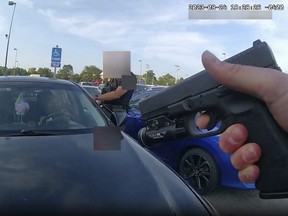 This still image from bodycam video released by the Blendon Township Police on Friday, Sept. 1, 2023, shows an officer pointing his gun at Ta’Kiya Young moments before shooting her through the windshield outside a grocery store in Blendon Township, Ohio, a suburb of Columbus, on Aug. 24. The pregnant Black mother was pronounced dead shortly after the shooting. Her unborn daughter did not survive. The video was pixelated by the source.