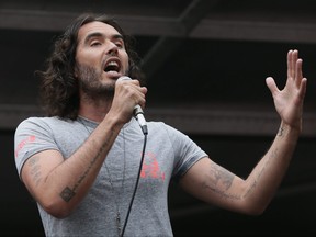 Comedian Russell Brand speaks in Parliament Square during a protest against the Conservative Government and it's austerity policies in London, Saturday, June 20, 2015.