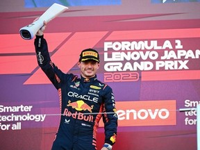 Winner Red Bull Racing's Dutch driver Max Verstappen celebrates on the podium at the end of the Formula One Japanese Grand Prix at the Suzuka circuit, Mie prefecture on September 24, 2023.