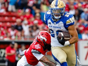 Winnipeg Blue Bombers Brady Oliveira runs the ball against the Calgary Stampeders during CFL football in Calgary on Saturday, July 30, 2022.