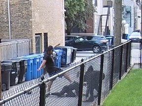 Screenshot of man getting attacked and robbed by two suspects in Chicago alley.