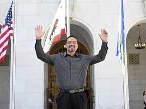 Gerardo Cabanillas waves from outside the Hall of Justice in downtown Los Angeles after his release on Tuesday, Sept. 26, 2023.