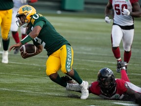 Edmonton Elks quarterback Tre Ford is tackled by an Ottawa Redblacks player at Commonwealth Stadium in Edmonton on Aug. 27, 2023. The Elks won 30-20 for their second straight victory after an 0-9 start to the season.