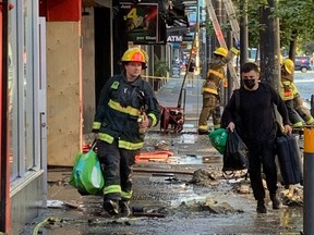 Vancouver firefighters work to put out a blaze at a backpacker hostel on Granville Street early Saturday morning. Photo: Doug Quan.