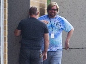Kerry Lemieux (light blue shirt) steps outside momentarily at Nora Frances Henderson Secondary School in Hamilton, Ont. on Tuesday, September 5, 2023.