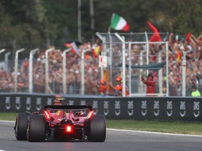Pole position qualifier Carlos Sainz passes celebrating fans during qualifying ahead of the F1 Grand Prix of Italy at Autodromo Nazionale Monza on September 2, 2023 in Monza, Italy.