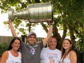 Alex Newhook hoists Stanley Cup after winning it with the Colorado Avalanche in 2022 and bringing it back home to St. John's, N.L. He is with his mother, Paula, father, Shawn, and sister Abby.