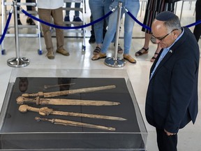 Israeli archaeologists show four Roman-era swords and a javelin head found during a recent excavation in a cave near the Dead Sea, in Jerusalem, Wednesday, Sep. 6, 2023.
