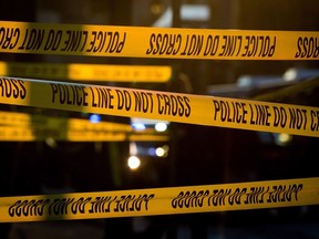 One man is in police custody after three people were stabbed at Vancouver's Light Up Chinatown festival. Police tape cordons off a crime scene in the Downtown Eastside of Vancouver, B.C., Thursday, April 9, 2015.