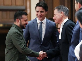 Ukrainian President Volodymyr Zelenskyy, with Prime Minister Justin Trudeau (centre), shake hands with House of Commons Speaker Anthony Rota during a ceremony on Parliament Hill on Sept. 22, 2023 in Ottawa.