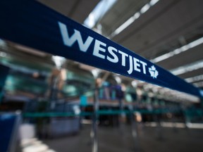 The union representing WestJet cabin crew is demanding an apology from the airline after Conservative Leader Pierre Poilievre delivered a speech on the public address system of a recent flight. A WestJet logo is seen in the domestic check-in area at Vancouver International Airport, in Richmond, B.C., on Friday, May 19, 2023.