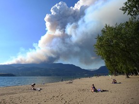 Smoke from the McDougall Creek fire is seen over Okanagan Lake from Kelowna, B.C., on Thursday, Aug. 17, 2023.