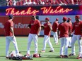 St. Louis Cardinals' Adam Wainwright, second from left, talks with Dusty Blake as the players warm up.