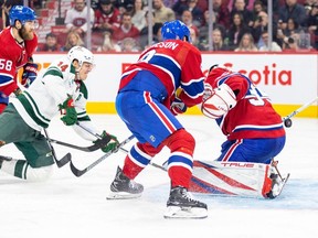 Minnesota Wild's Joel Eriksson Ek, #14, shoots the puck past Montreal Canadiens' David Savard, left, Mike Matheson and goalie Sam Montembeault for a goal during the second period of a National Hockey League game in Montreal Tuesday Oct. 17, 2023.