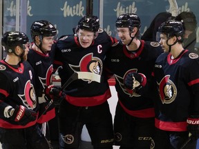 Ottawa Senators left wing Brady Tkachuk (7) celebrates his goal with teammates Claude Giroux, left to right, Tim Stutzle, Jake Sanderson and Artem Zub during third period NHL action against the Tampa Bay Lightning, in Ottawa, Sunday, Oct. 15, 2023. THE CANADIAN PRESS/Adrian Wyld