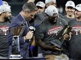 Adolis Garcia of the Texas Rangers celebrates with the ALCS MVP Trophy after defeating the Houston Astros.