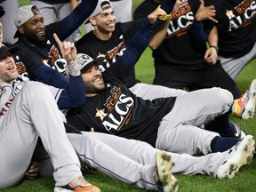 Jose Altuve #27 of the Houston Astros celebrates with his team after the victory against the Minnesota Twins in Game Four of the Division Series at Target Field on October 11, 2023 in Minneapolis, Minnesota.