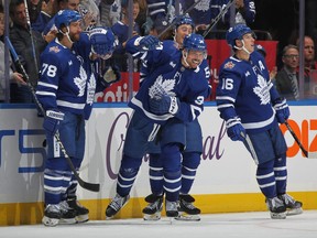 Auston Matthews, centre, of the Toronto Maple Leafs celebrates his third goal of the game against the Minnesota Wild during the third period in an NHL game at Scotiabank Arena on Saturday, Oct. 14, 2023, in Toronto.
