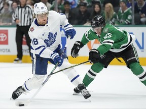 William Nylander of the Toronto Maple Leafs shoots the puck as Wyatt Johnston of the Dallas Stars defends during the second period at American Airlines Center on Thursday, Oct. 26, 2023, in Dallas.