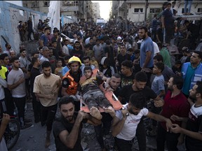 Palestinians carry an injured person