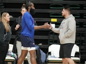 Philadelphia 76ers guard James Harden, left, greets Brandon Chinn, 76ers Director of Basketball Communications, during the NBA basketball team's practice on Thursday, Oct. 5, 2023, in Fort Collins, Col.
