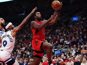 Toronto Raptors' O.G. Anunoby (3) drives as Minnesota Timberwolves' Nickeil Alexander-Walker (9) and Rudy Gobert (left) defend during first half NBA basketball action in Toronto on Wednesday, October 25, 2023.