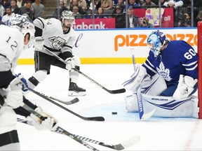 Los Angeles Kings' Phillip Danault (24) skates in to score against Toronto Maple Leafs goaltender Joseph Woll during first period NHL hockey action in Toronto, on Tuesday, October 31, 2023.THE CANADIAN PRESS