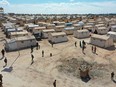 An aerial view shows medics at the Maram camp for the internally displaced in Syria's northwestern Idlib province on March 7, 2023, during a vaccination campaign.