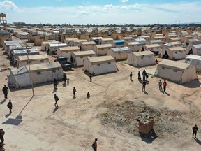 An aerial view shows medics at the Maram camp for the internally displaced in Syria's northwestern Idlib province on March 7, 2023, during a vaccination campaign.