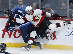 Jets' Dylan Samberg and Ottawa Senators' Mark Kastelic collide during their pre-season game in Winnipeg on Thursday, October 5, 2023.