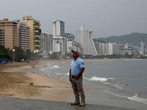 A municipal police officer stands guard before the arrival of Hurricane Otis in Acapulco, Guerrero state, Mexico on October 24, 2023.