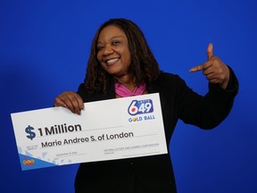 Marie Andree Sanon holds her $1-million cheque after winning on the Aug. 23, 2023 Lotto 6/49 gold ball ticket.