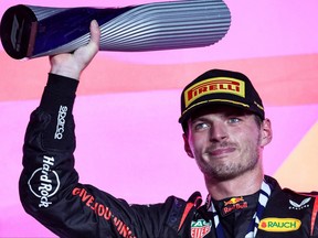 Red Bull Racing's Dutch driver Max Verstappen celebrates on the podium following the Qatari Formula One Grand Prix at Lusail International Circuit on Oct. 8, 2023.