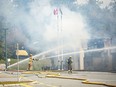 Port Coquitlam firefighters put out a fire at Hazel Trembath elementary school in Port Coquitlam, Saturday, October 14, 2023. The overnight fire destroyed much of the school.