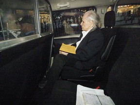 Seen through a police vehicle window, Peter Nygard arrives to a Courthouse in Toronto, Ontario, Canada, on Tuesday, October 3, 2023 as the trial for former fashion executive Peter Nygard’s charges of sexual assaults continues in a Toronto courtroom. THE CANADIAN PRESS/Cole Burston