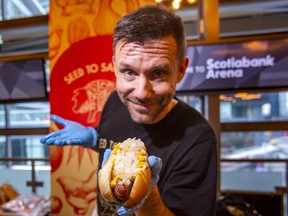Michael McKenzie, founder of Seed to Sausage, poses with the Original 6ix Hot Dog, one of the new concession offerings this year at Toronto's Scotiabank Arena.