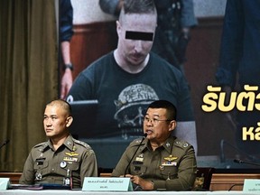 Thai National Police Chief Damrongsak Kittiprapas, right, speaks during a press conference regarding the extradition of Matthew Dupre (on screen), a Canadian man wanted over the suspected murder of Indian gangster Jimi 'Slice' Sandhu in Phuket on February 4, 2022, at the Crime Suppression Division in Bangkok on May 29, 2023.