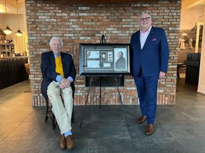 Donald Sutherland and Canada Post President and CEO Doug Ettinger pose with a framed stamp enlargement in a handout photo.