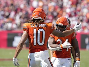 Chicago Bears wide receiver Chase Claypool (10) celebrates scoring a touchdown with teammate running back Khalil Herbert (24) during the second half of an NFL football game, Sunday, Sept. 17, 2023, in Tampa, Fla.
