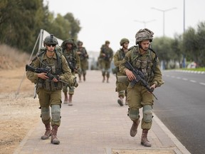Israeli soldiers arrive at Sderot, a town close to the Gaza Strip, Wednesday, Oct.11, 2023.THE CANADIAN PRESS/AP/Ohad Zwigenberg