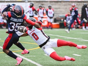 Montreal Alouettes' Reggie Stubblefield (35) and Ottawa Redblacks' Bralon Addison (0) go up for a catch during first half CFL football action in Montreal, Monday, Oct. 9, 2023.